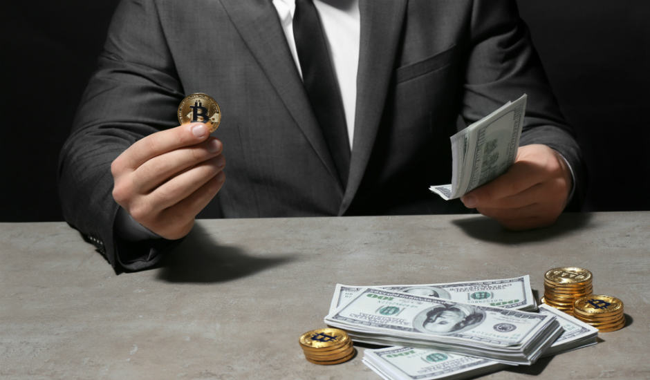 Man with golden Bitcoin. Source: Shutterstock