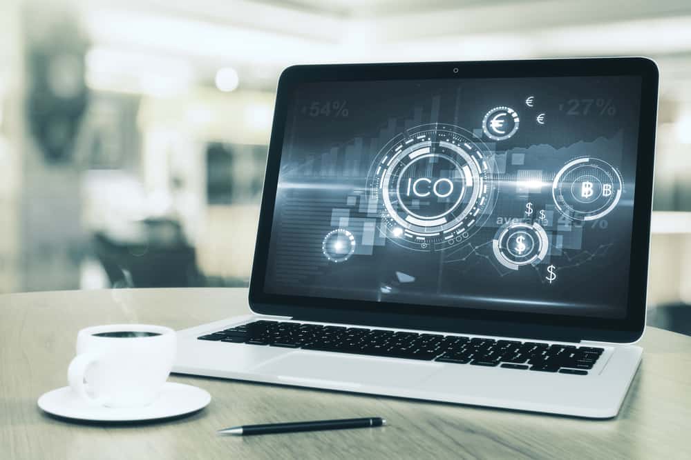 Laptop with abstract ICO interface on screen. Source: Shutterstock