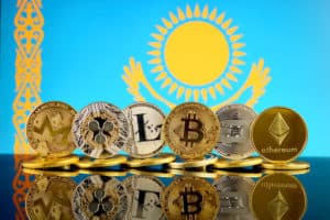 Physical version of Cryptocurrencies (Monero, Ripple, Litecoin, Bitcoin, Dash, Ethereum) and Kazakhstan Flag. Source: Shutterstock.com