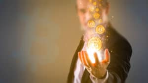 Concept of man creating Bitcoins with his hand. Source: shutterstock.com