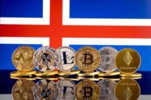 Physical version of Cryptocurrencies (Monero, Ripple, Litecoin, Bitcoin, Dash, Ethereum) and Iceland Flag. Source: shutterstock.com