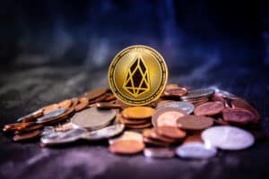 Golden EOS.IO and mound of money. Digital cryptocurrency concept.