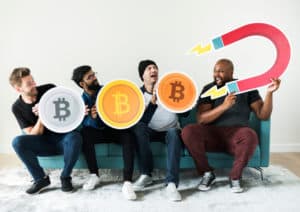 Group of diverse friends sitting on couch cryptocurrency concept. Source; shutterstock.com