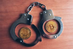 Handcuffs and bitcoins, conceptual image for cryptocurrency related police arrest. Source: shutterstock.com