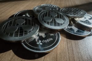 Ripple XRP crypto currency coins stack on table. Source: shutterstock.com