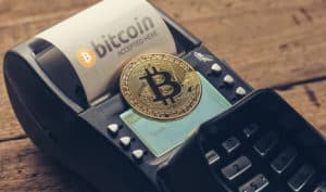 Customer pays by bitcoin to pay a bill at the cafe (bitcoin accepted here). Source: shutterstock.com
