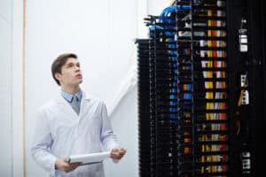 Engineer of data center looking at new bitcoin hardware while working in storage room. Source; shutterstock.com