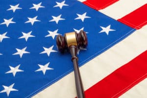 Wooden judge gavel over USA flag - studio shoot. Source; shutterstock.com