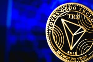 tron coin cryptocurrency on the blue background. Source; shutterstock.com