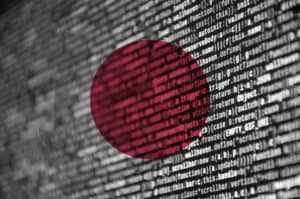 Japan flag is depicted on the screen with the program code. The concept of modern technology and site development