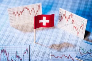 Swiss flag with rate tables and graphs for economic development.