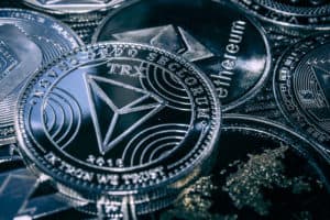 Coin cryptocurrency Tron on the background of the main altcoins Ethereum, dash, monero, litecoin, Iota.