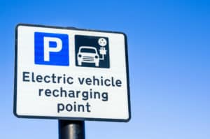 Recharging Point for Electric Vehicles Sign against Clear Sky