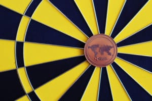 Ripple coin in the middle of dartboard. Ripple investment as a goal. - Image
