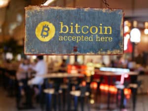 sign bitcoin accepted here hanging in front of restaurant door. bitcoin , electronic money concept - Image