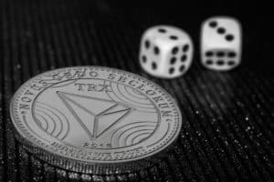 The coin cryptocurrency Tron and rolling dice. - Image