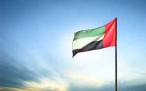 A United Arab Emirates flag flying against clean and tranquil sky. UAE celebrates it's national day on 2nd December every year. - Image