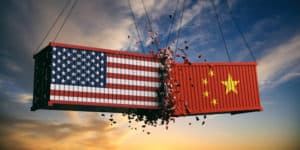 USA and China trade war. US of America and chinese flags crashed containers on sky at sunset background. 3d illustration - Illustration